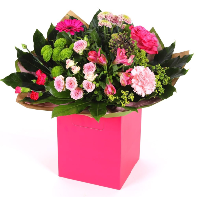 Blushing Meadow - A stunning collection of pink and green seasonal flowers in toning packaging. This bouquet is designed to impress and uplift any space.