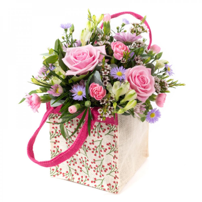 A Little Something - Show your affection with this mouth-watering mix of classical flowers delivered in a delightful gift bag or box.